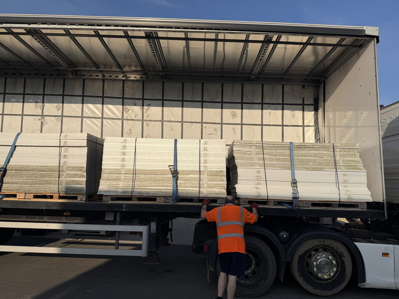 Olital team member securing a full trailer load of end-of-life solar panels during a bulk collection