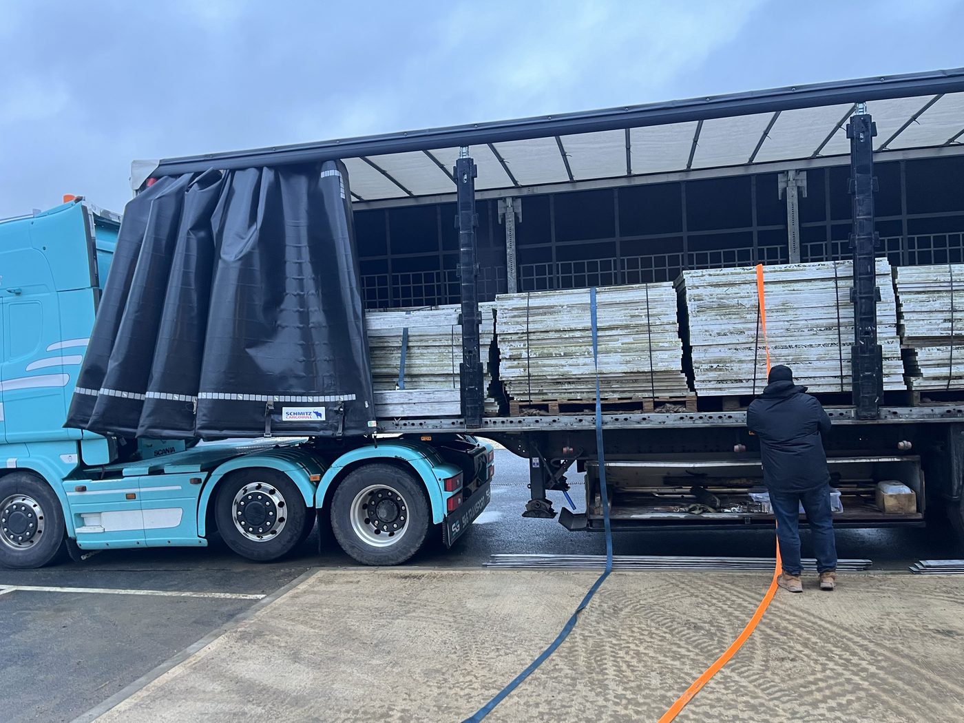 Articulated lorry loaded with pallets of solar panels during a commercial site clearance